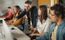 Business owner with colleagues working at computers