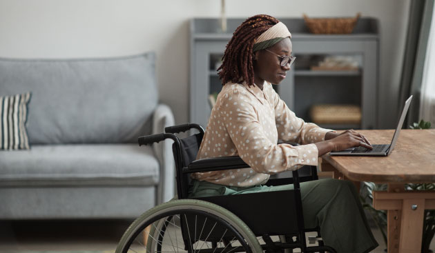 Young black woman in a wheel chair on her laptop