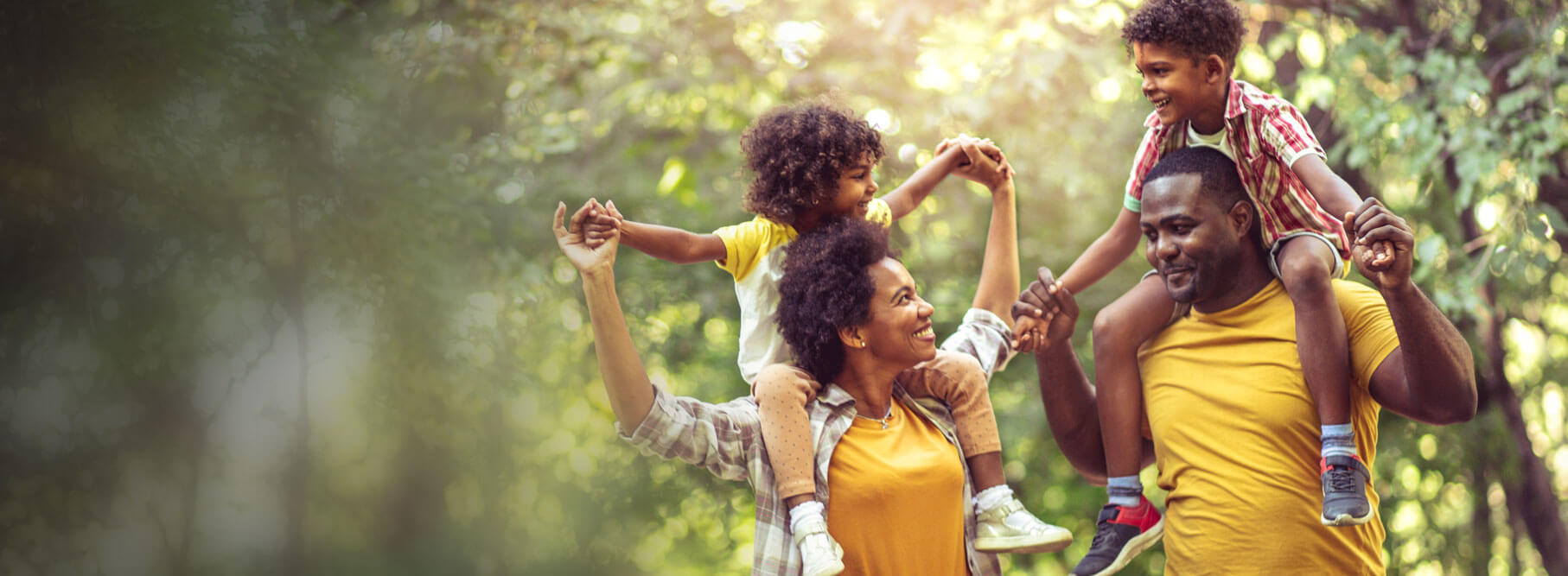 A black family has fun at a park.